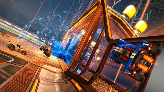 Best PC games - Rocket League: A blue car driving up the wall as a goal is scored against the orange team