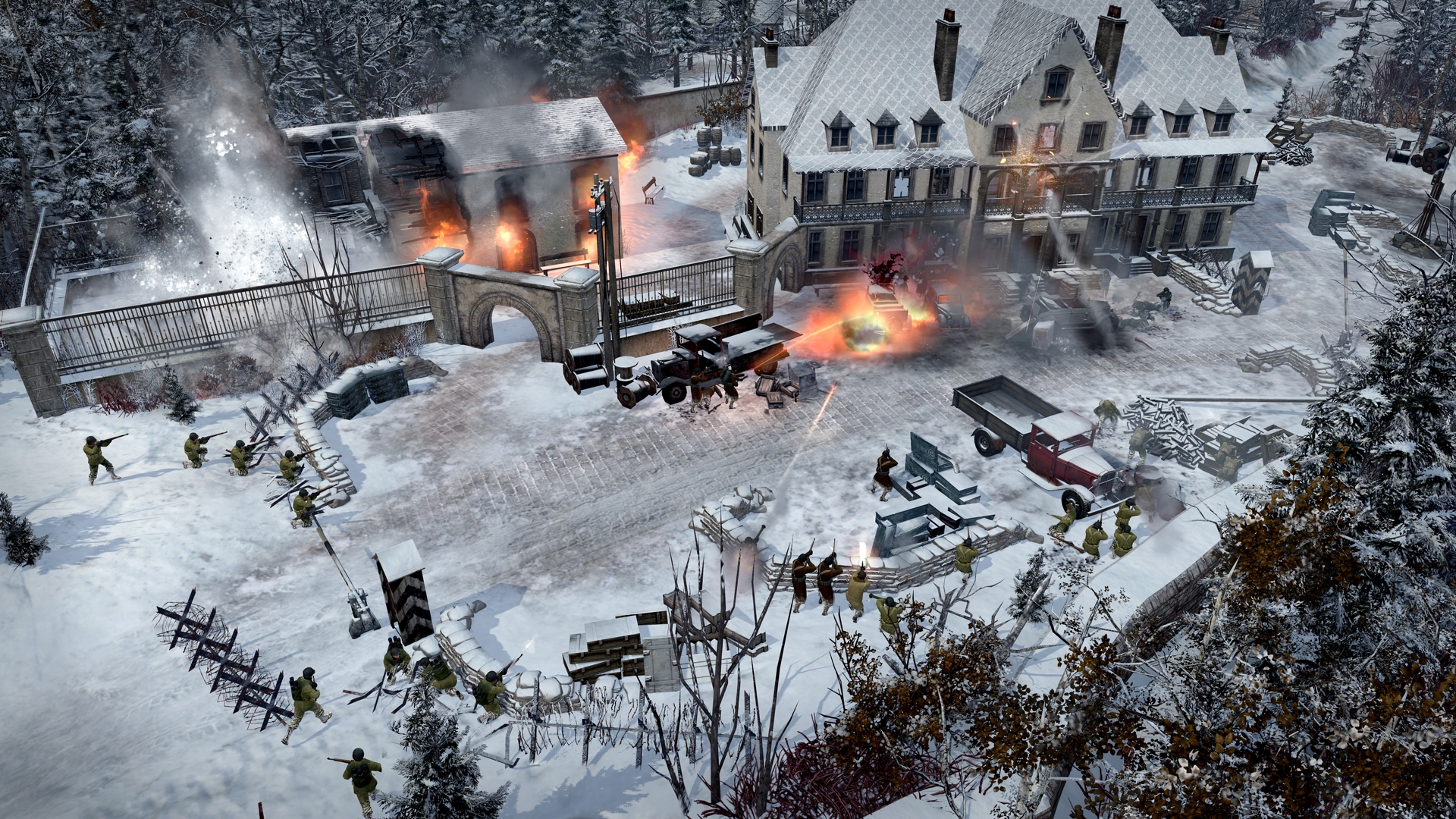 Best strategy games: a manor house covered in snow is being shot at by troops surrounding it in Company of Heroes 2: Ardennes Assault.. A barn is on fire.