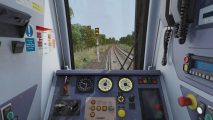 best train games: the inside of a train showing off the main panel and a window showing the main track
