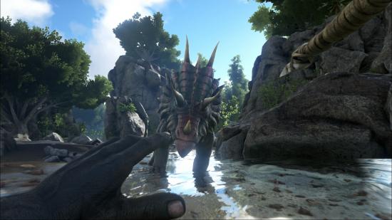 A man aims a spear at a dinosaur in one of the best dinosaur games, Ark: Survival Evolved