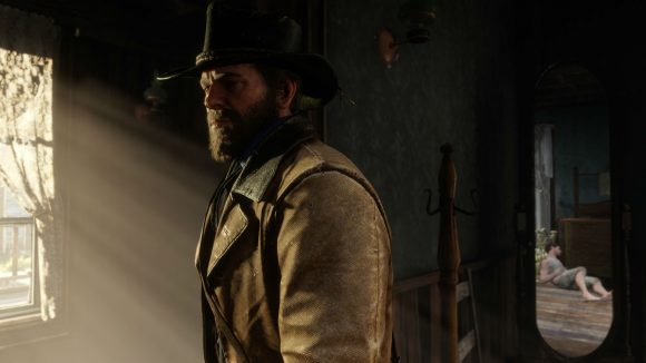 A brooding cowboy stood in a dark room