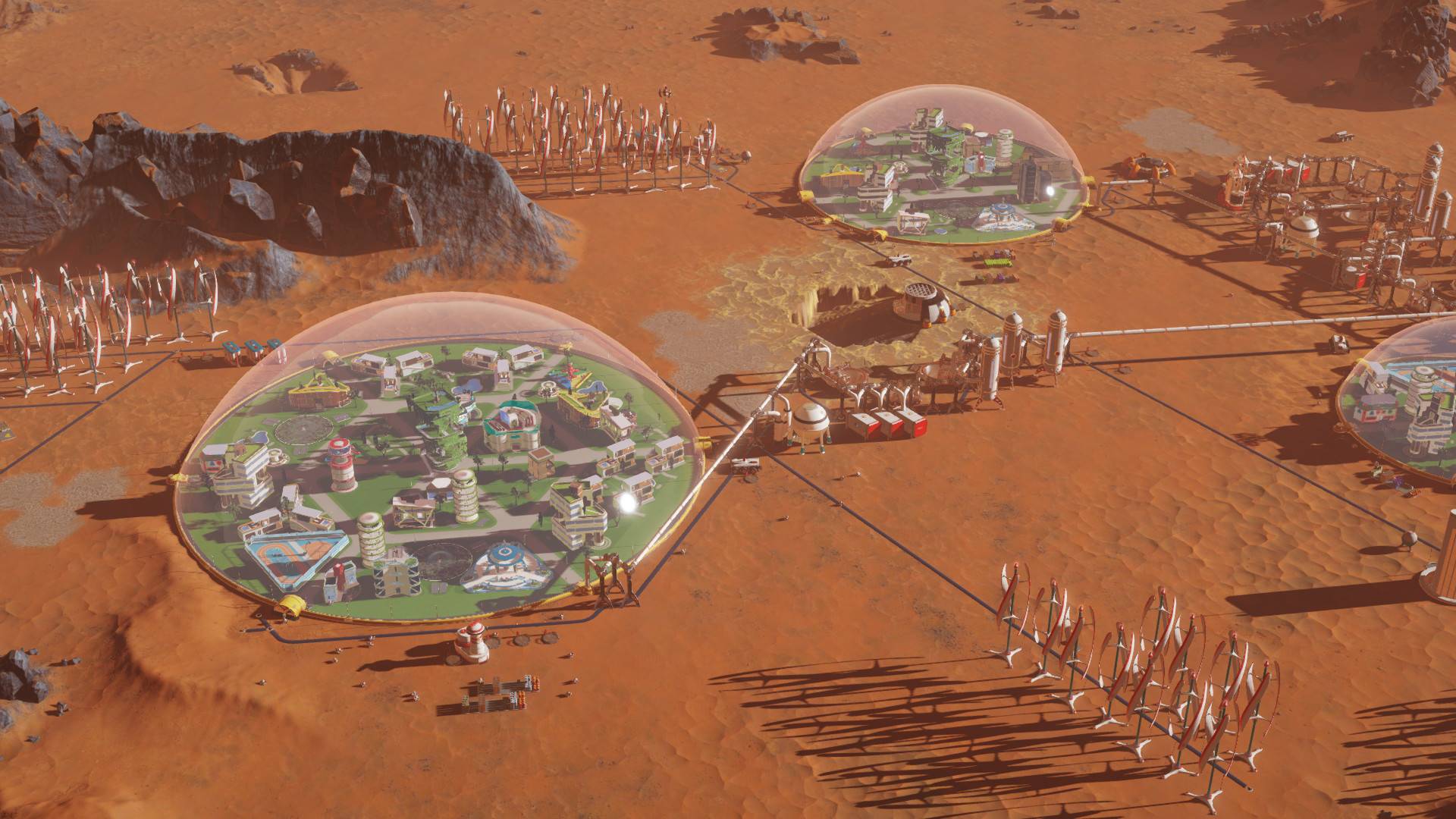 Best city-building games: Surviving Mars. Image shows two settlements on Mars within biospheres.