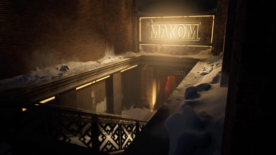 A flight of stairs leading down to a nightclub with a glowing yellow sign that says 'MAKOM'