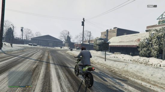 Best GTA 5 mods - a man riding a motorbike through the snowy streets of North Yankton.