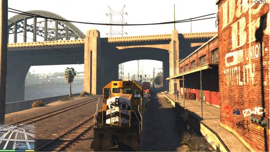 Best GTA 5 mods - a train is passing through a bridge in Los Santos.