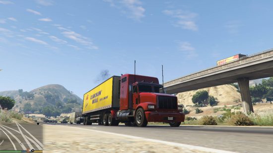 Best GTA 5 mods - a red truck with a yellow cargo hold driving down a freeway.