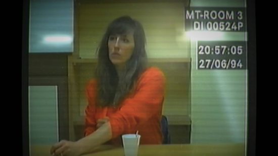 Best story games - Old videotape footage of a brunette woman in an orange jumpsuit being questioned by detectives in Her Story.