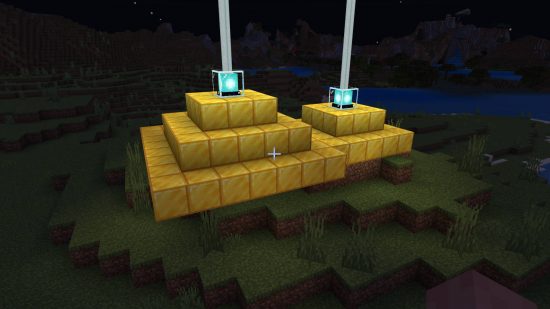 Minecraft-baken - twee bakens die boven gouden blokken gloeien.