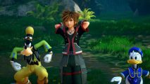 Sora, the main protagonist of Kingdom Hearts 3, stands next to Disney's Donald Duck and Goofy in a forest