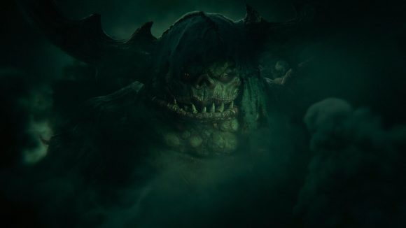 The bloated, jowelly face of a Great Unclean One, Greater Daemon of Nurgle, lit in green smoke in Total War: Warhammer 3