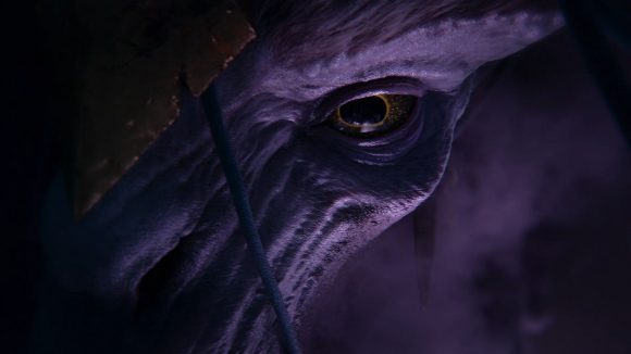 The serpentine face of a Keeper of Secrets, a Greater Daemon of Slaanesh, in Total War: Warhammer 3