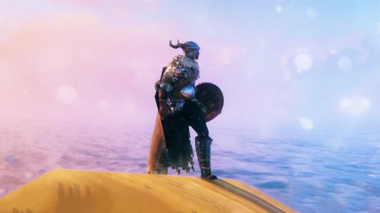 A Viking in Valheim standing in front of a sunrise