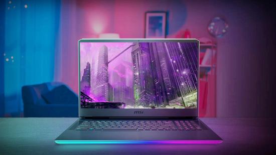 MSI's GE76 Raider gaming laptop sits on a desk in a living room with blue and pink RGB lighting