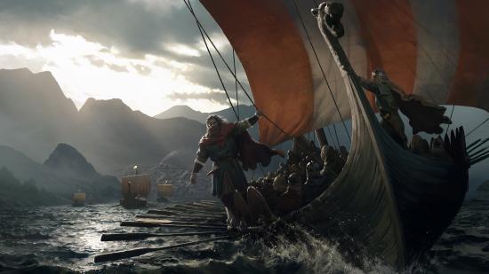 A man in medieval garb stands on the side of a viking longship at sea, mountains behind him