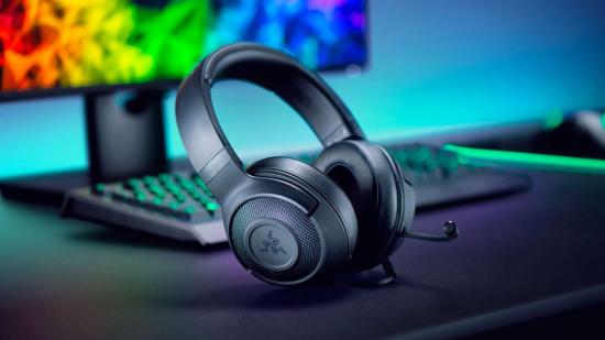 Razer headset placed on a desk behind an array of other RGB-clad Razer products