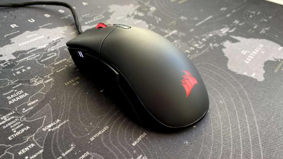 A side view of Corsair's black gaming mouse on a large mouse mat