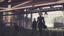 2B and 9S walk through the wreckage of Nier: Automata