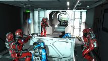 Three red coloured men in space suits and weapons hold a corridor, the bodies of blue team around them.