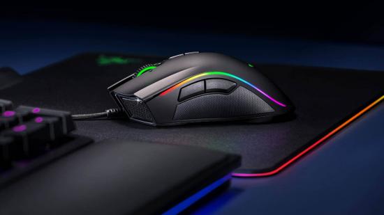 Razer's Mamba Elite gaming mouse sits on an RGB mouse pad next to a gaming keyboard