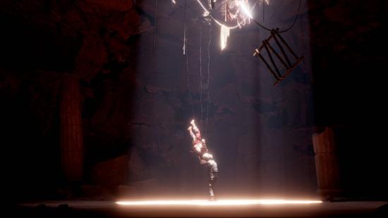 A soldier dangling on a rope in a dark underground cave