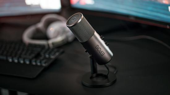 The new EPOS B20 gaming microphone sits on a desk pointed towards the user