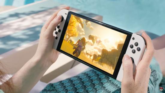 The new Nintendo Switch OLED playing The Legend of Zelda Breath of the Wild 2, with white joycons