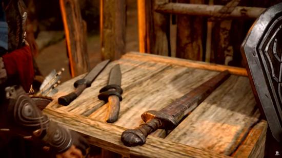 A crude one-handed sword rests on a worktable in Assassin's Creed Valhalla