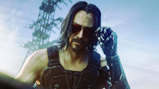Best Cyberpunk 2077 mods: Johnny Silverhand using his robot hand to remove his sunglasses. There is a slight green tint to the image that has been added in post to show off the Matrix style.