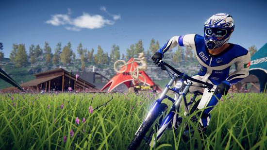 Descenders biker racing through the grass, with the game on sale as part of War Child UK's sports games Steam sale