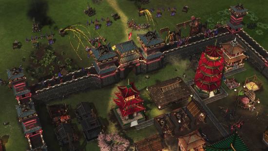 Catapults and rocket wagons fire missiles at a fortified castle in Stronghold: Warlords.