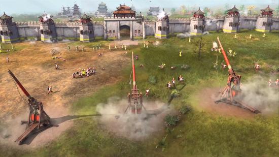 A line of trebuchets firing at a castle wall in rts game age of empires 4