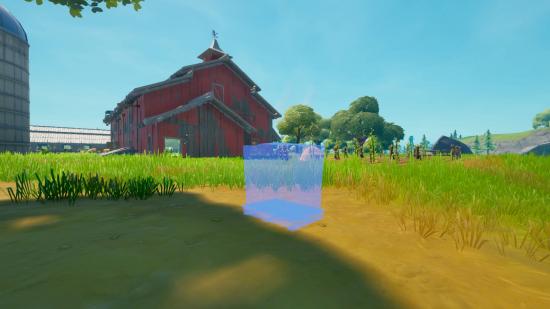 A blue outline of a cat food pallet outside a red barn in Fortnite.