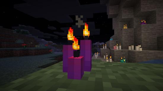 How to make a Minecraft candle: Three purple Minecraft candles give off light on the floor of an Ancient City