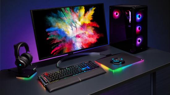 Corsair's K100 RGB gaming keyboard sits next to other peripherals, each shining rainbow RGB lighting
