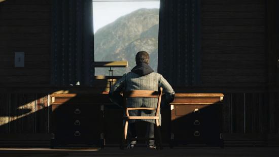 Alan Wake stares out of the window in Alan Wake Remastered