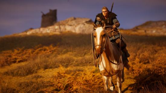 Eivor rides a horse across an open hillside at sunset in Assassin's Creed Valhalla