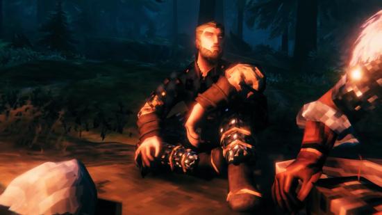 A low-polygon Viking sits by a campfire in Valheim.