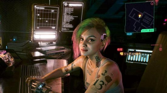 Judy Alvarez from Cyberpunk 2077 sitting at desk surrounded by computer screens