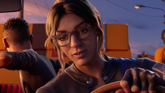 A woman with glasses and brown hair takes the wheel of a car in Saints Row gameplay footage