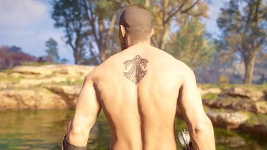 A shirtless Eivor displaying the Assassin's Creed Brotherhood tattoo in Valhalla