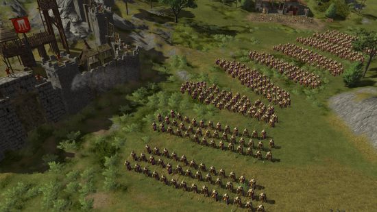 Games like Total War: A battalion of soldiers split into platoons standing ready beside a stone castle in Hegemony III - Clash of the Ancients.
