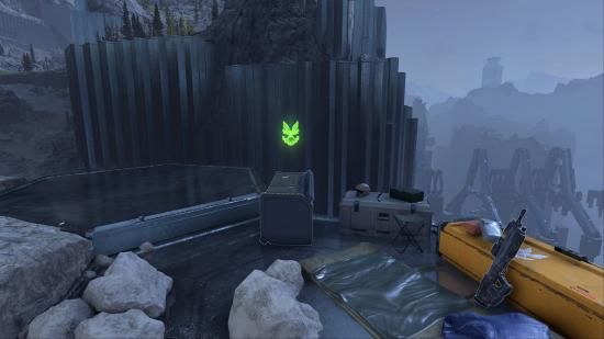 One of the Mjolnir Armory caches that contains one of the Halo Infinite multiplayer skins. It's been knocked over precariously close to a cliff edge.