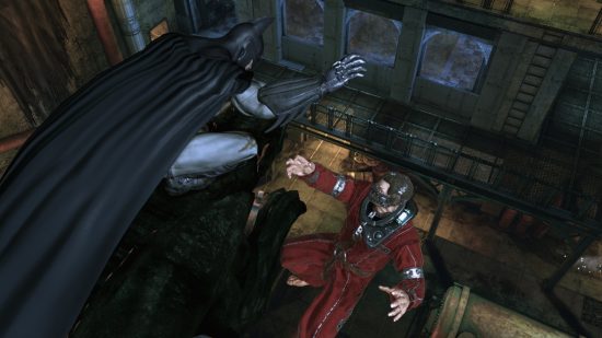 Best action-adventure games - Batman drops a bad guy off a grotesque in Batman: Arkham Asylum.