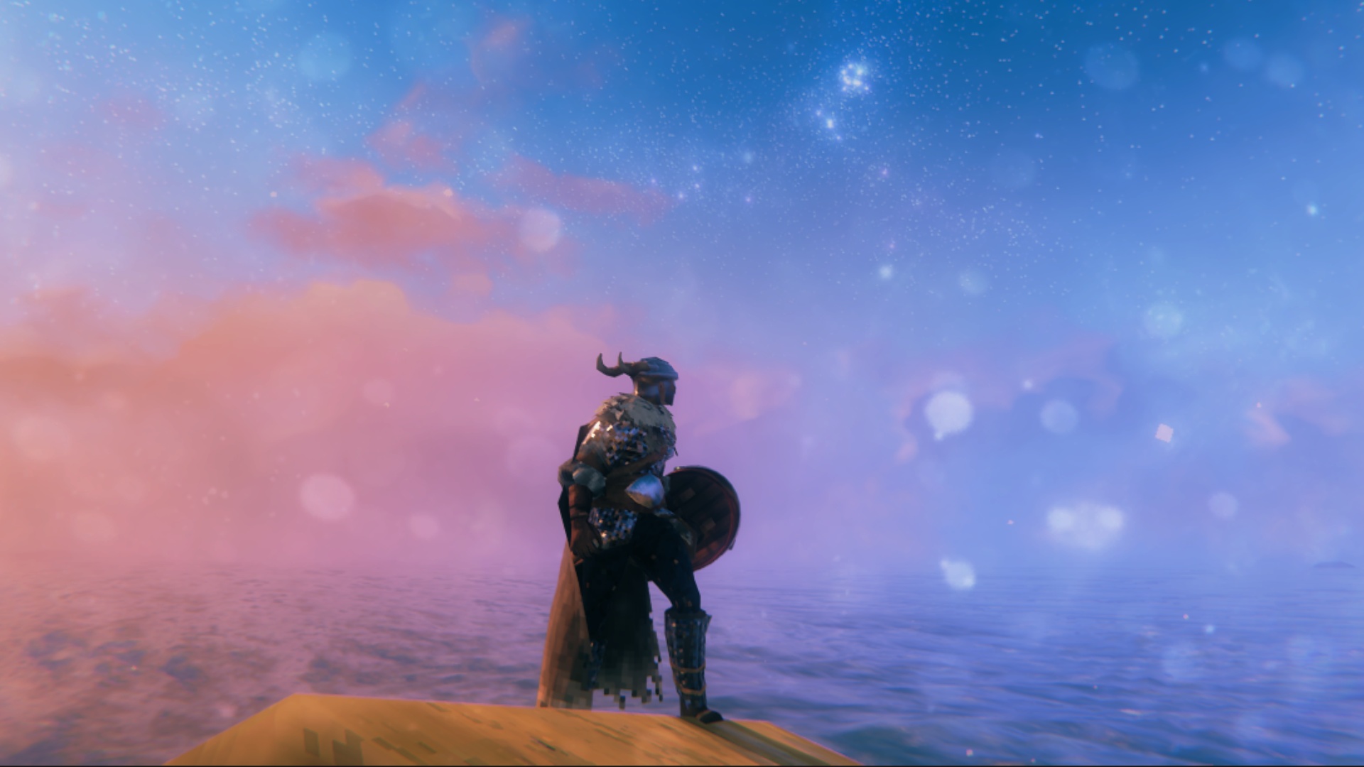 Best indie games: Valheim, Image shows a viking standing on the shore as the sun sets over the water.