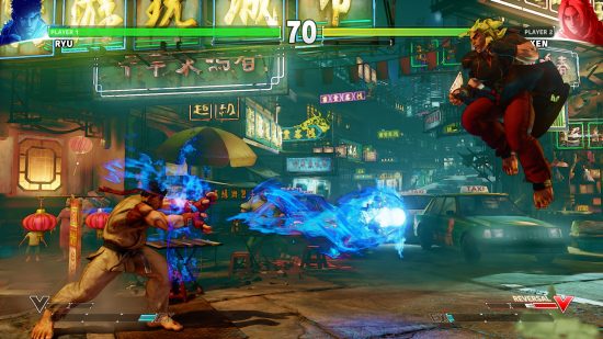 Best fighting games - Ryu throwing a fireball at Ken, who is jumping around in a Chinese market in Street Fighter V.