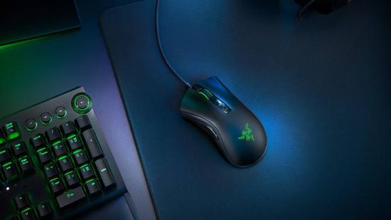 Razer DeathAdder V2 gaming mouse on blue tint gaming desk