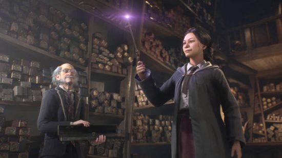Hogwarts Legacy release date: an aspiring witch holding a wand with a purple tip. The wandmaker is holding the case, standing in front of many shelves full of wand boxes.