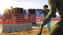 GTA Online weekly update: players walk towards a red line while firing a gun