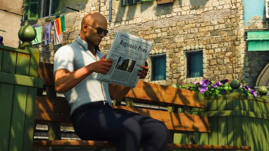 PCGamesN news writer 2022; Hitman's Agent 47 sits on a bench while reading a newspaper in a Spanish town