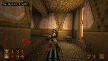 A heavy trooper fires at the player, with pixelated blood droplets flying away from the camera in the remastered version of Quake.